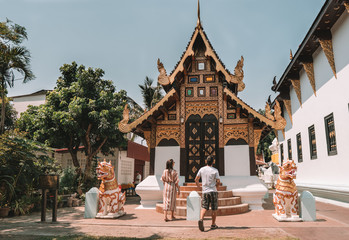 Couple watches a buddhist temple in the city of Chiang Mai, Thailand