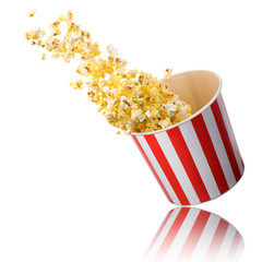 Flying popcorn from paper striped bucket isolated on white background