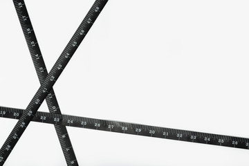 Black Measure tape isolated on white background. Weight loss, diet, overweight concept. Copy space