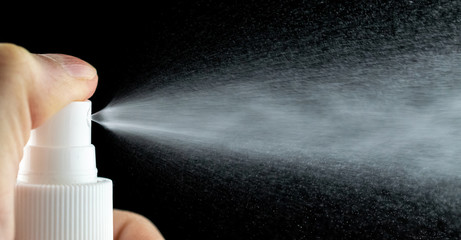 Water mist splash bottle isolated on black background. Spray liquid aerosol for perfume. - obrazy, fototapety, plakaty