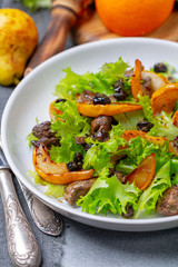 Salad with fried chicken liver and pears.