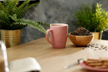 Hot tea on the table while relaxing with free space for an advertising product