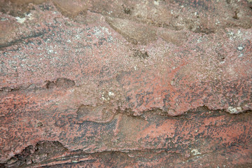 Abstract texture of hewn unpolished stone pink granite