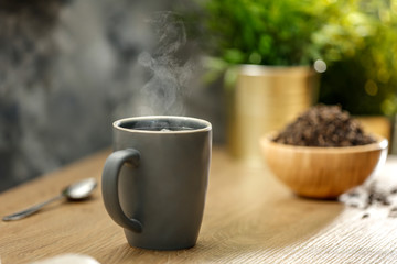 Hot tea on the table while relaxing with free space for an advertising product