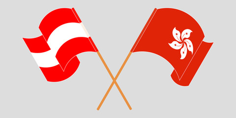 Crossed and waving flags of Hong Kong and Austria