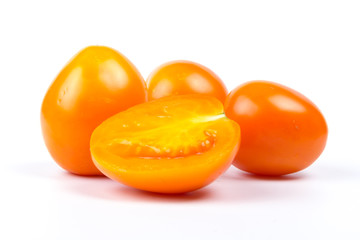 Yellow fresh tomatoes  isolated on white background in close-up