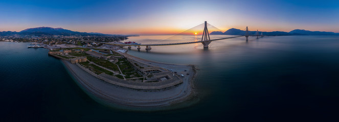 Wide panorama of world famous  Rio - Antirio Harilaos Trikoupis bridge at sunset time