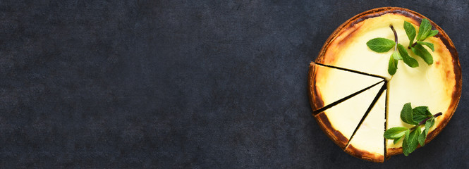 Vanilla cheesecake on a black concrete background. Top view.Advertising. Restaurant menu.