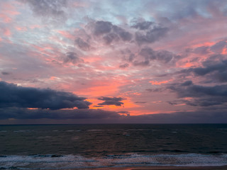 Naklejka na ściany i meble A vibrant sunrise over the Atlantic Ocean
