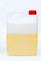 Plastic canister with yellow liquid on white background.