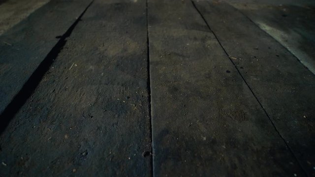 Wooden floor of boards in the abandoned workshop building, dolly close up shot low angle