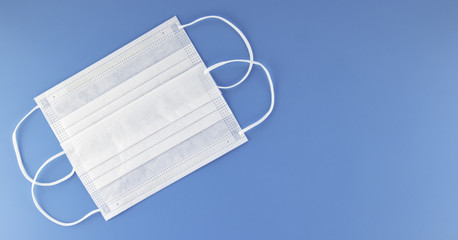 Surgical white face mask on blue background. Prevent coronavirus,dust protection and breathing...