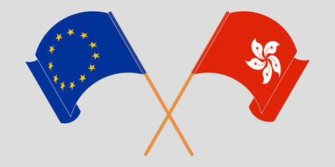 Crossed and waving flags of Hong Kong and the EU