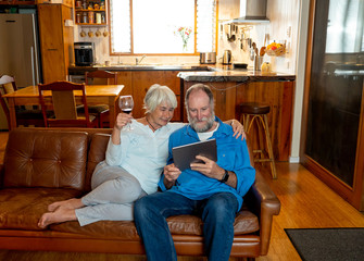 Obraz premium COVID-19 outbreak. Senior couple video calling family celebratin