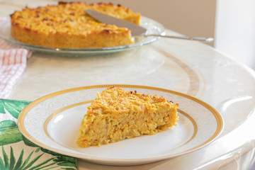 Homemade Roasted vegetable quiche pie with a wedge cut out. Delicious vegetarian food. freshly baked
Onions carrots squash courgettes KUGEL
