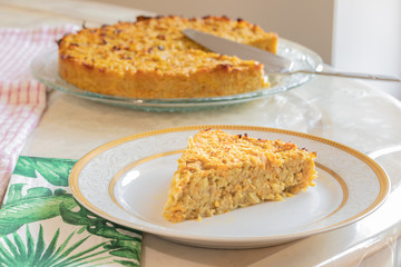 Homemade Roasted vegetable quiche pie with a wedge cut out. Delicious vegetarian food. freshly baked
Onions carrots squash courgettes KUGEL