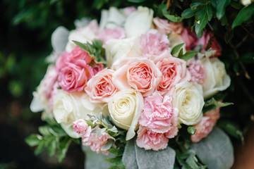 Beautiful wedding bouquet on the green grass on a summer day