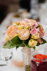 A beautiful stylish bouquet stands on the table close-up