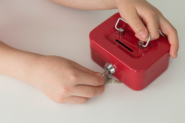 accumulate for poor people or investment. Coins,hand and red moneybox on the white background for charity foundation concept.child throwing money into piggy bank.