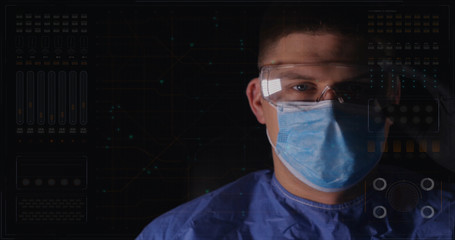 Doctors having an online video conference analyze a patient's medical MRI diagnosis by checking on a large glass screen with futuristic holograms. Concept of: medicine, doctors, future, holography