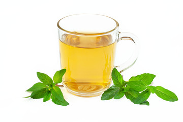 A glass of mint tea surrounded by sprigs of fresh mint on a white background   © Monika