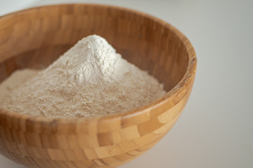 Wooden bowl with white flour