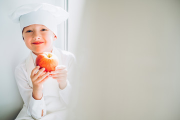 little cook in the kitchen preparing food