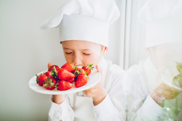 the little cook tastes fresh strawberries