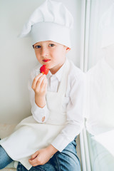 the little cook tastes fresh strawberries