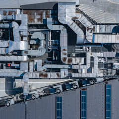 Ventilation System on the Building Roof. Rainy Weather. Industrial Air system of ventilation and Air conditioning. Aerial Shot.