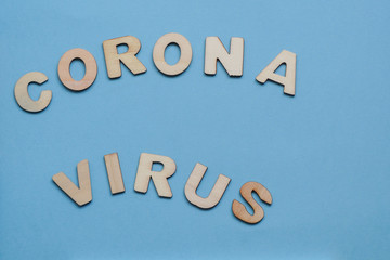 The word coronavirus on a blue background of wooden letters on Blue background. Virus pandemic protection concept