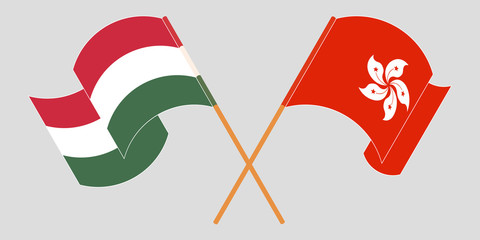 Crossed and waving flags of Hong Kong and Hungary