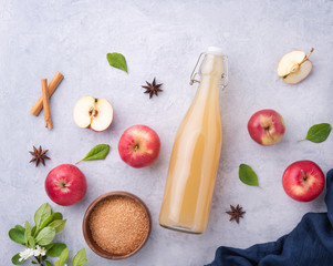 fresh home made Apple drink with spices and brown sugar on a blue background
