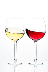Two glasses with wine on a white background. Red wine. White wine. Apple juice. Cherry juice.