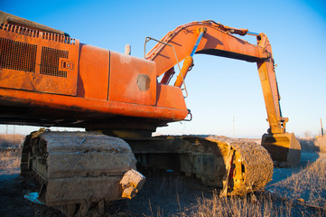Bulldozer removes a wild dump