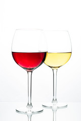 Two glasses with wine on a white background. Red wine. White wine. Apple juice. Cherry juice.