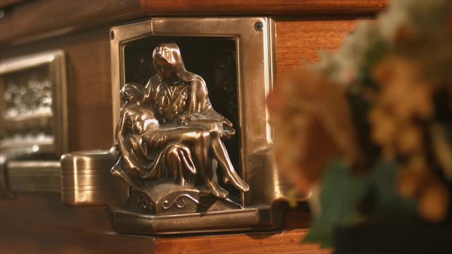 coffin with flowers in chapel