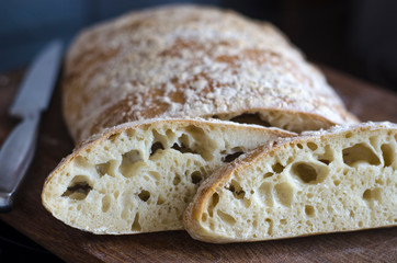 Italian ciabatta bread sliced on a board