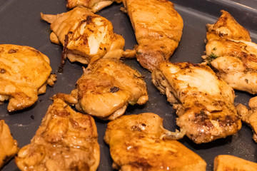 fried chicken fillet on a metal grill. Preparation of dishes from poultry