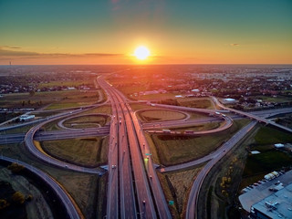 A beautiful panoramic aerial drone view of the sunset on the highway overpass of the southern...