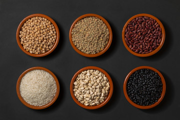Bowls with legumes. Lentils, chickpeas, rice and different kinds of beans.