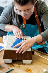 Processing elements of colored glass for stained glass.