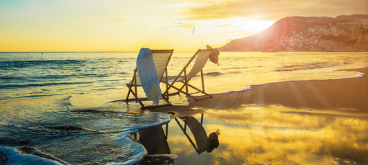 Background with couple of deck chairs at sunset, Travel concept, Summer background