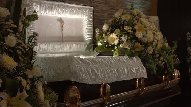 coffin with flowers in chapel