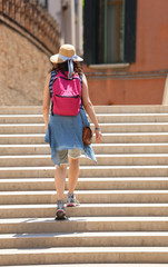 Young woman walking on the staircase