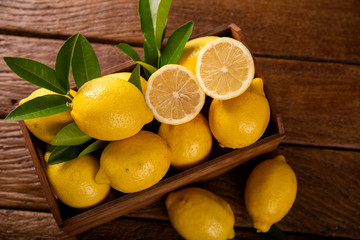 Wood box with lemons on green wooden background