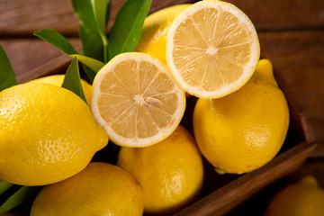 Wood box with lemons on green wooden background