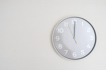 White clock hanging on white background