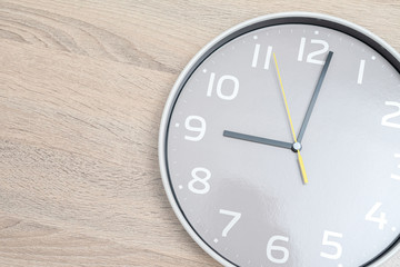 Close up White clock hanging on Wood background