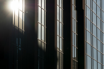 Concept of financial economics future. The glass background of the business office skyscraper with reflected sun shine